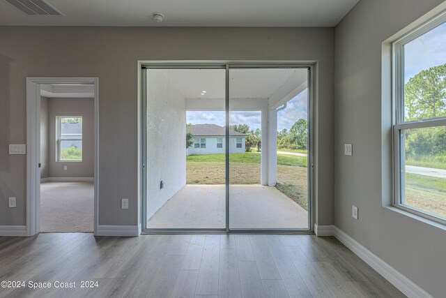 doorway with light hardwood / wood-style floors