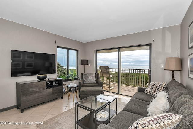 tiled living room featuring a water view