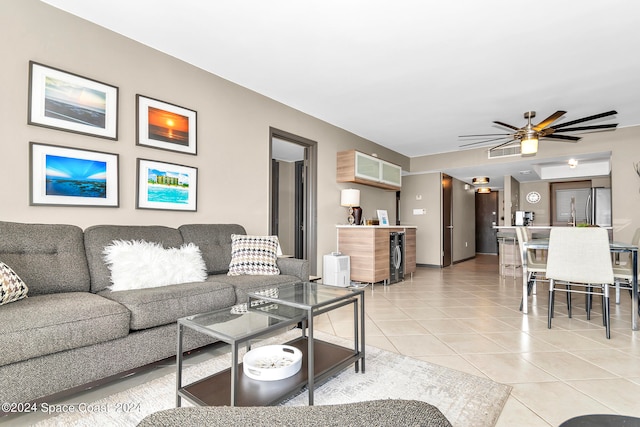 tiled living room with beverage cooler and ceiling fan