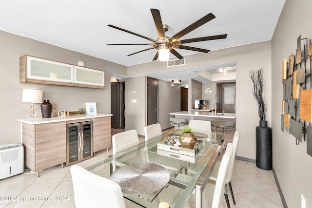 tiled dining area with beverage cooler and ceiling fan