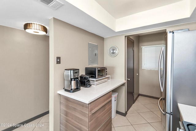 kitchen featuring appliances with stainless steel finishes, electric panel, and light tile patterned flooring