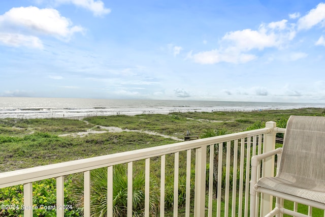 balcony featuring a beach view and a water view