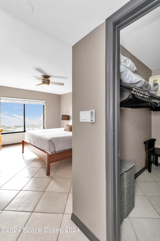 tiled bedroom featuring ceiling fan