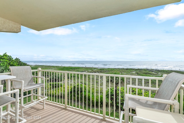 balcony featuring a beach view and a water view