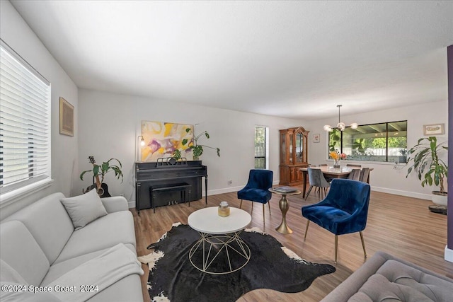 living room featuring an inviting chandelier and light wood-type flooring