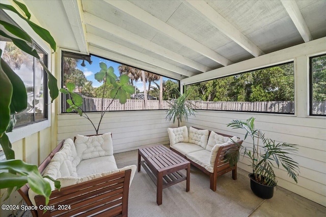 sunroom with beamed ceiling and plenty of natural light