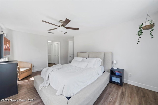 bedroom with dark wood-type flooring and ceiling fan