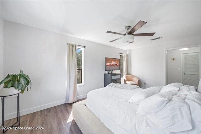 bedroom with ceiling fan and hardwood / wood-style flooring