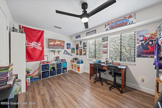 home office featuring a textured ceiling, wood-type flooring, and ceiling fan