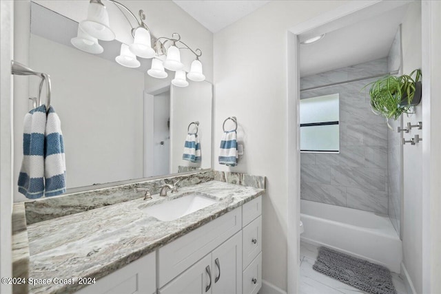 full bathroom featuring tiled shower / bath, toilet, and vanity