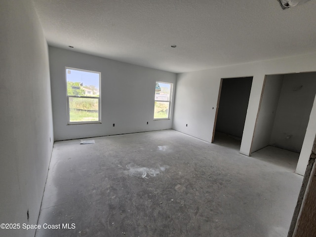 empty room featuring a textured ceiling