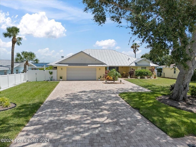 ranch-style house featuring a garage and a front yard