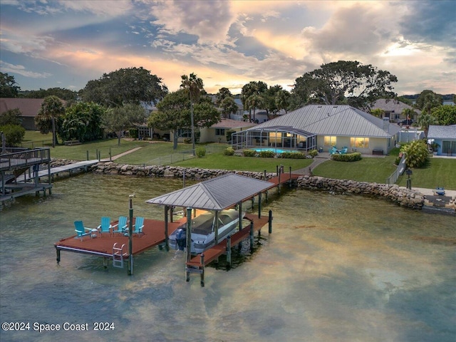 dock area featuring glass enclosure and a yard