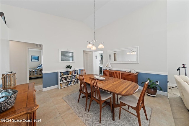 tiled dining space with a notable chandelier and high vaulted ceiling