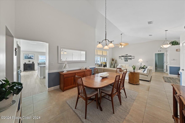 dining room featuring high vaulted ceiling and light tile patterned floors