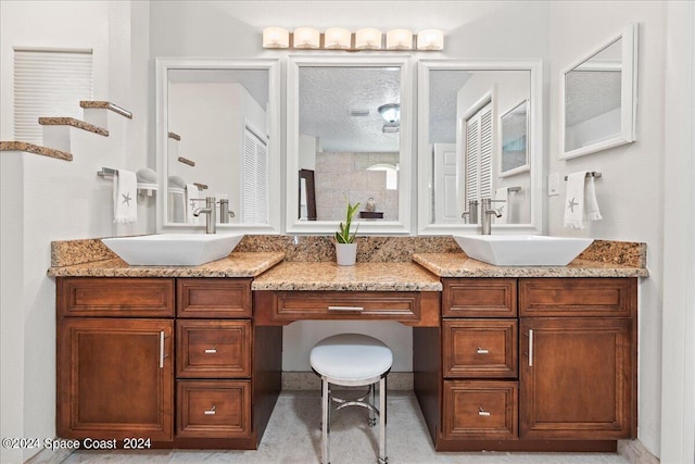 bathroom featuring vanity and a textured ceiling