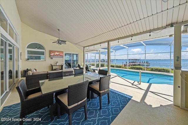 exterior space with an outdoor living space, a lanai, a water view, and ceiling fan