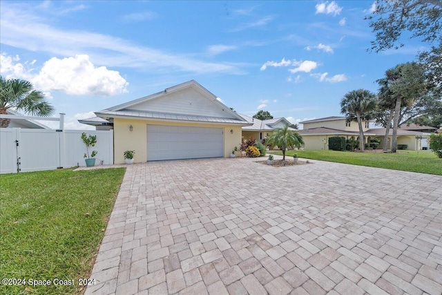 ranch-style home with a garage and a front yard