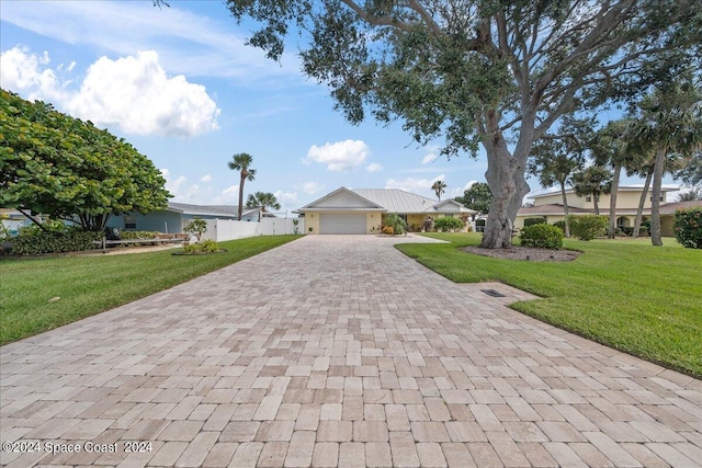 view of front of house featuring a garage and a front yard