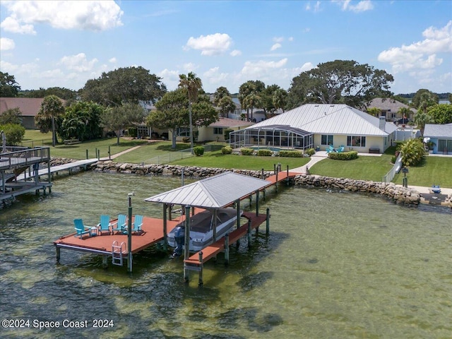 dock area featuring glass enclosure, a yard, and a water view