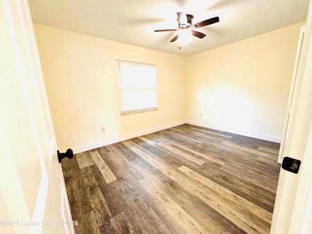 spare room with ceiling fan, hardwood / wood-style flooring, and a textured ceiling