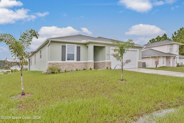 view of front of property with a front yard and a garage