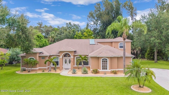 mediterranean / spanish house with a front lawn