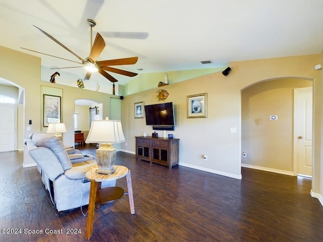 living room featuring vaulted ceiling, dark hardwood / wood-style floors, and ceiling fan