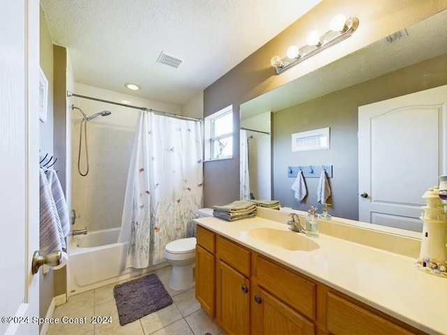 full bathroom featuring tile patterned flooring, a textured ceiling, shower / bathtub combination with curtain, vanity, and toilet