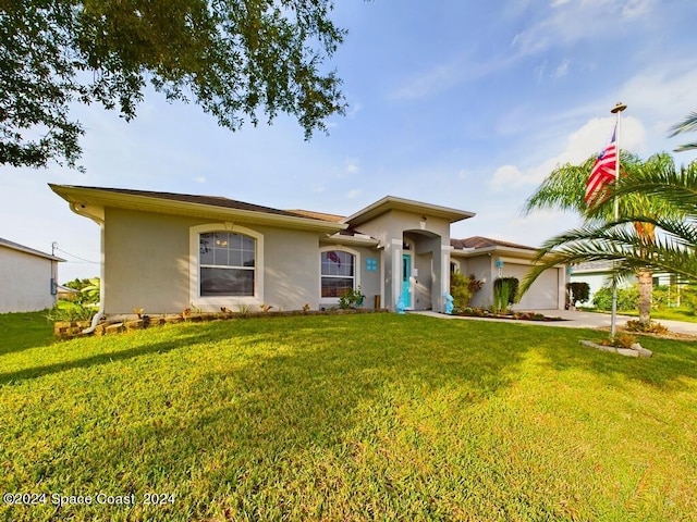 view of front of home with a garage and a front yard