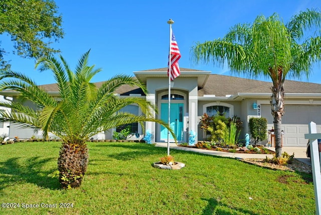 view of front of property with a garage and a front yard