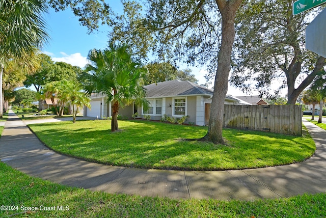 ranch-style home with a front yard and a garage