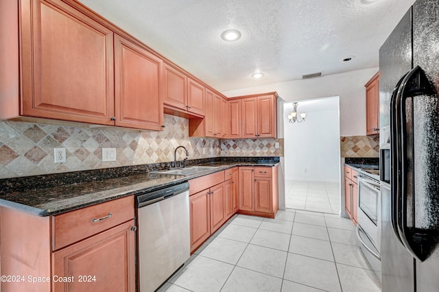 kitchen with dark stone counters, dishwasher, a chandelier, sink, and black fridge with ice dispenser