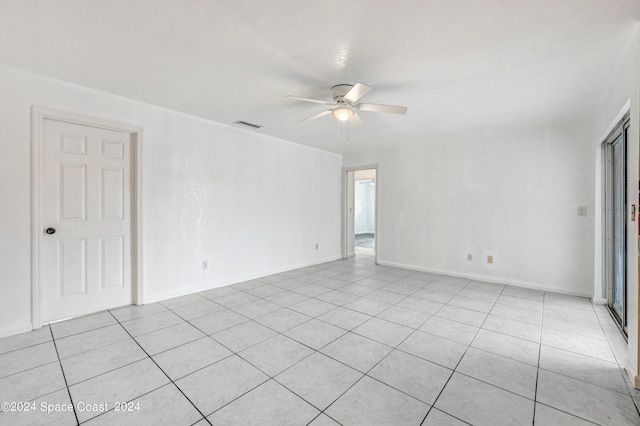 empty room with light tile patterned flooring and ceiling fan