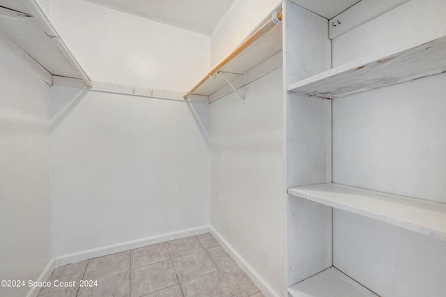 spacious closet with light tile patterned floors