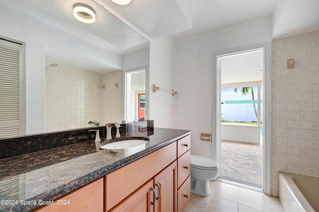bathroom with a shower, tile patterned flooring, vanity, toilet, and a bath