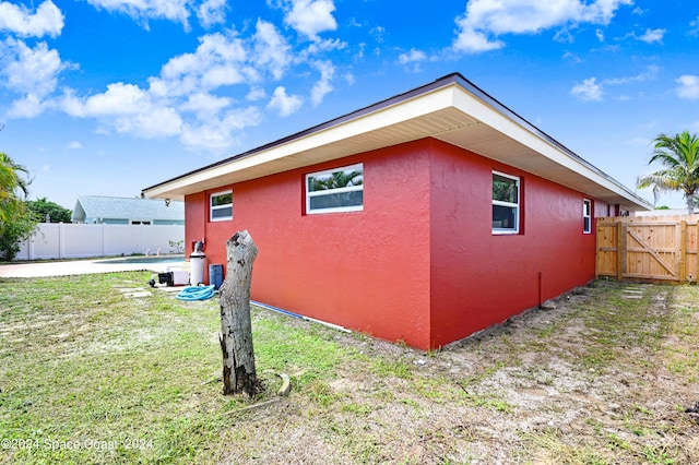 view of home's exterior with a lawn and a patio