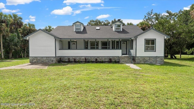 cape cod-style house with a front yard and a shingled roof