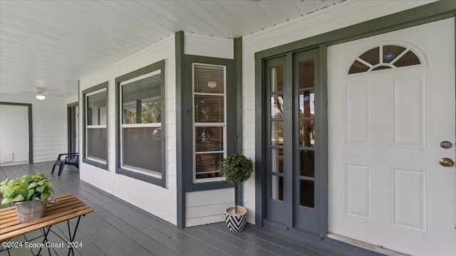 wooden terrace featuring a porch and french doors