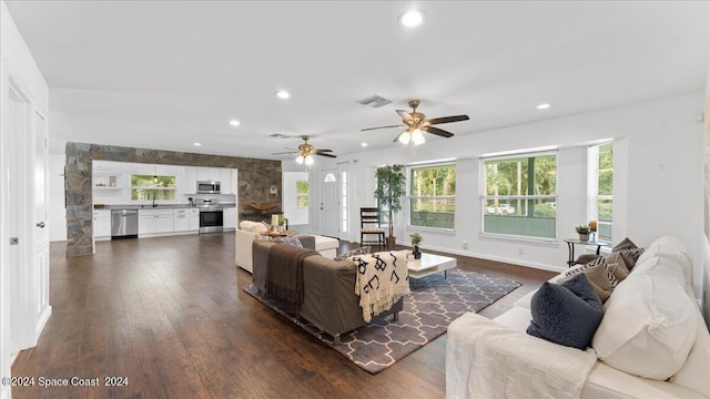 living room with ceiling fan, dark hardwood / wood-style floors, sink, and a healthy amount of sunlight