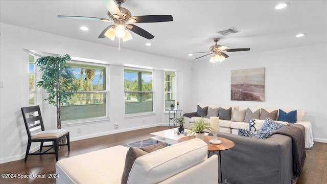 living room featuring dark wood-type flooring and ceiling fan