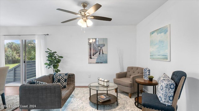 living room with ceiling fan and hardwood / wood-style floors