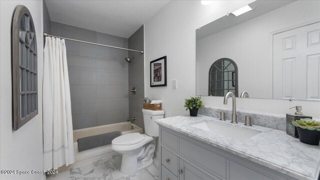 full bathroom with vanity, toilet, and shower / tub combo with curtain