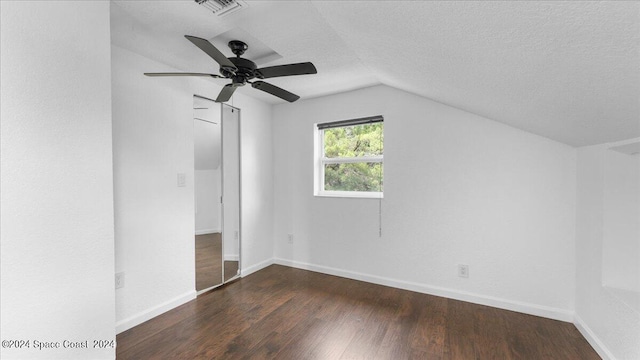 bonus room featuring a textured ceiling, dark hardwood / wood-style flooring, ceiling fan, and lofted ceiling