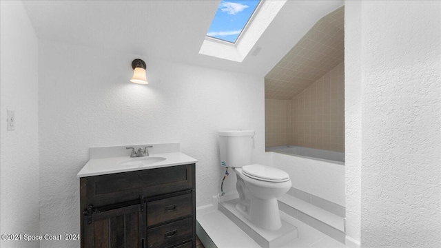 full bathroom with vanity, toilet, tiled shower / bath, and lofted ceiling with skylight