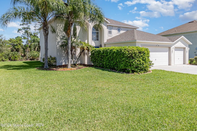 view of front of home featuring a front lawn and a garage