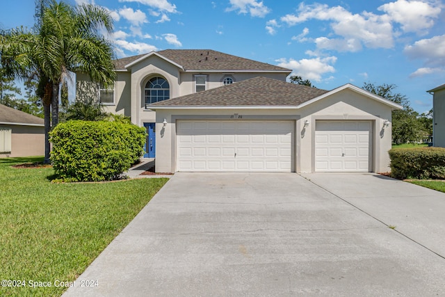 front of property with a front yard and a garage