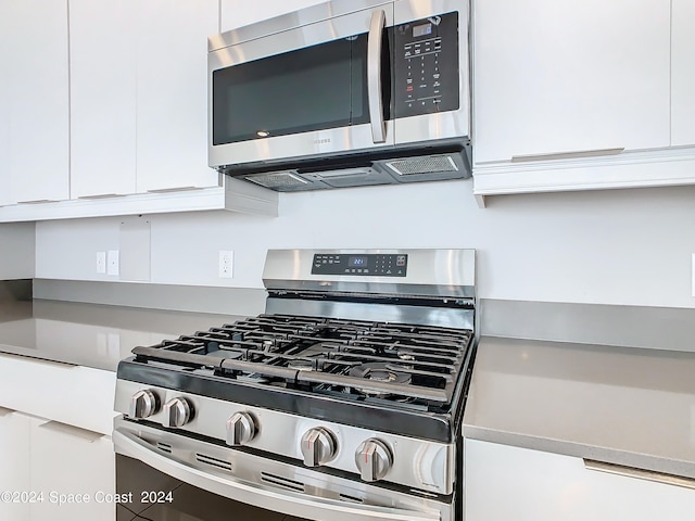 kitchen featuring appliances with stainless steel finishes and white cabinetry