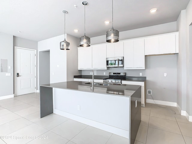 kitchen featuring an island with sink, sink, appliances with stainless steel finishes, and white cabinetry