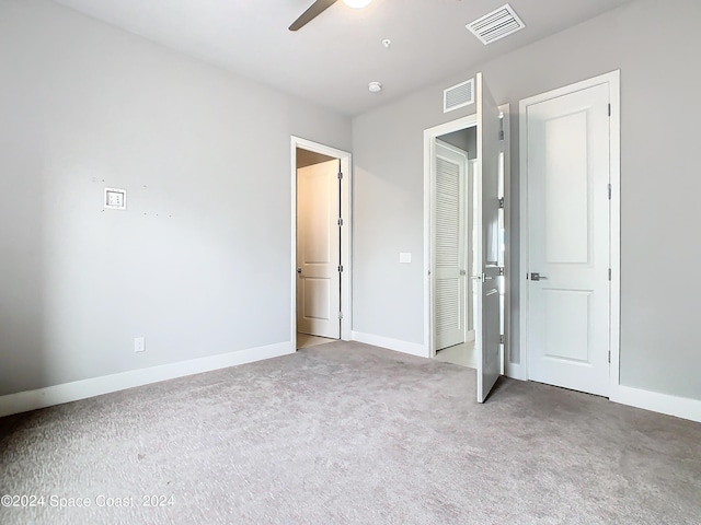 unfurnished bedroom with ceiling fan and carpet floors